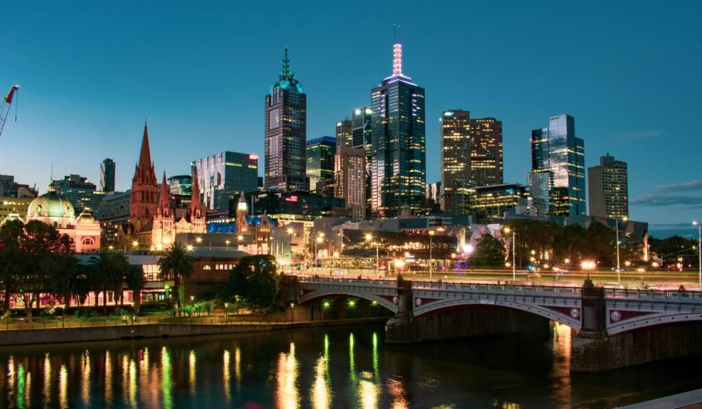 A captivating view of Melbourne's skyline reflected in the Yarra River during dusk.